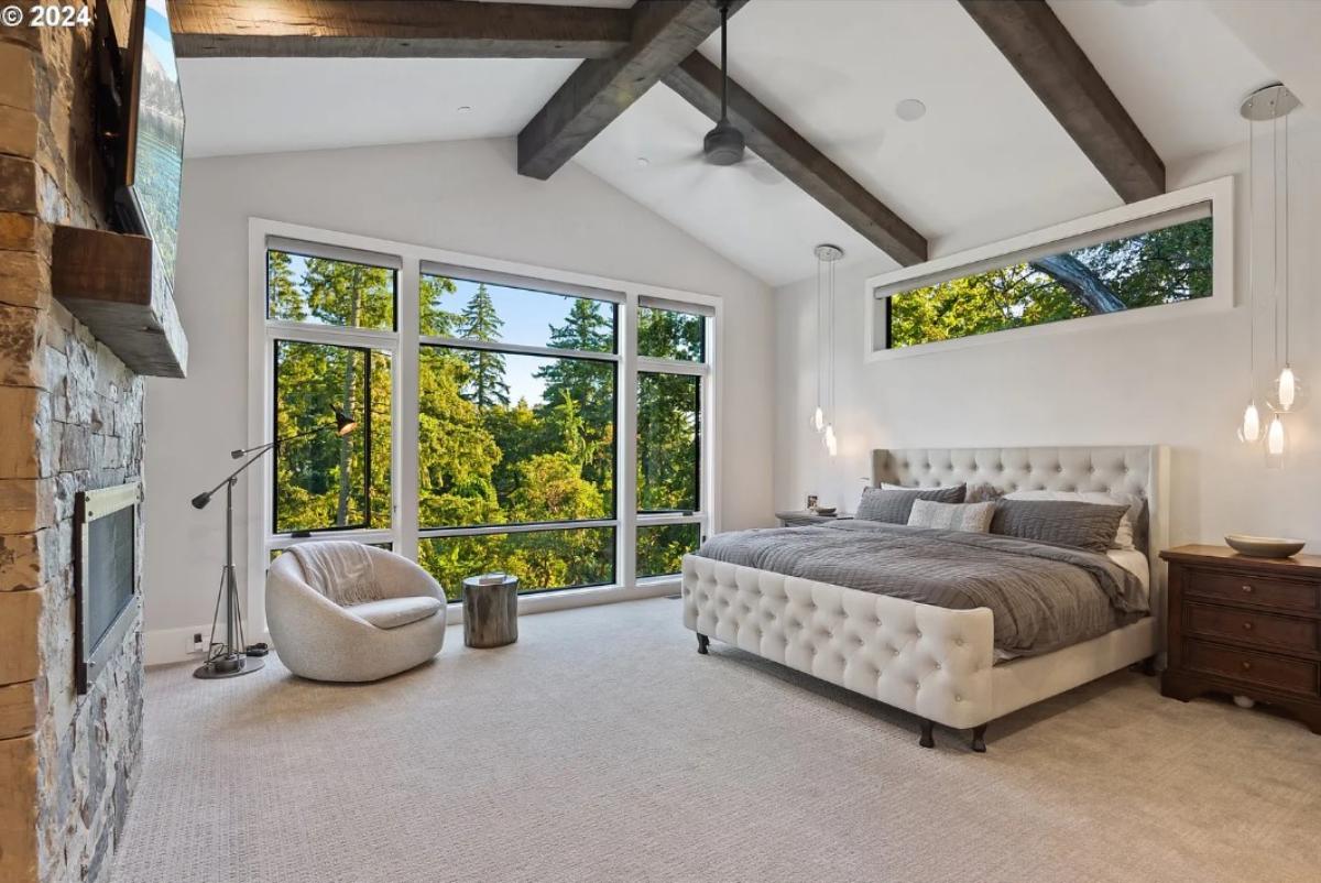 Bedroom with a glass windows and carpet flooring.