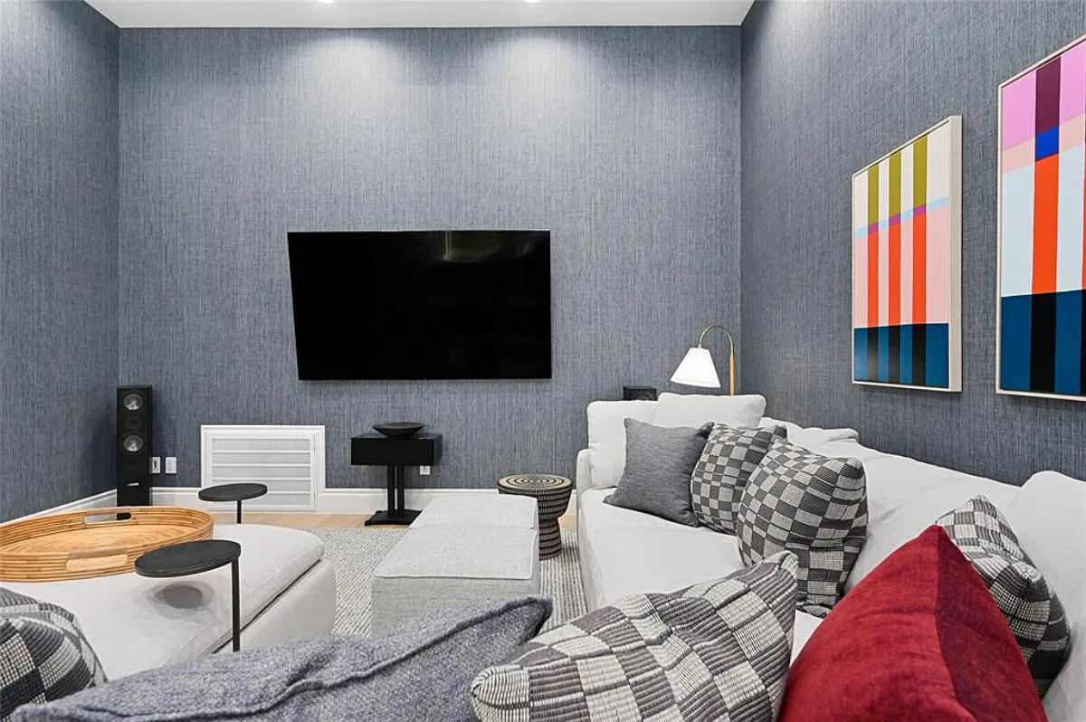 Media room with couches and a TV.