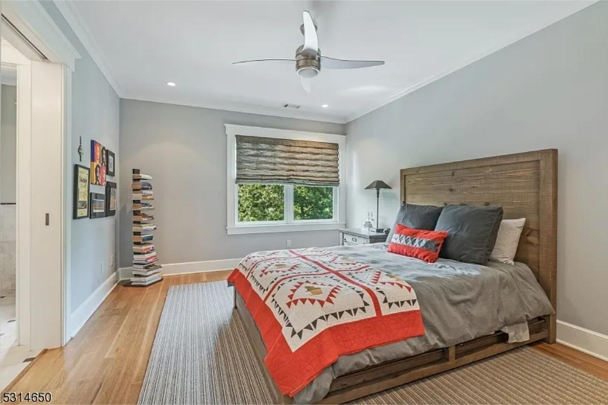 Bedroom with a large bed and hardwood floors.