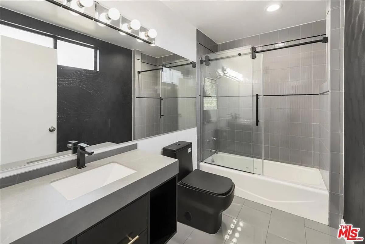 Bathroom with a sink, toilet and a walk-in shower.