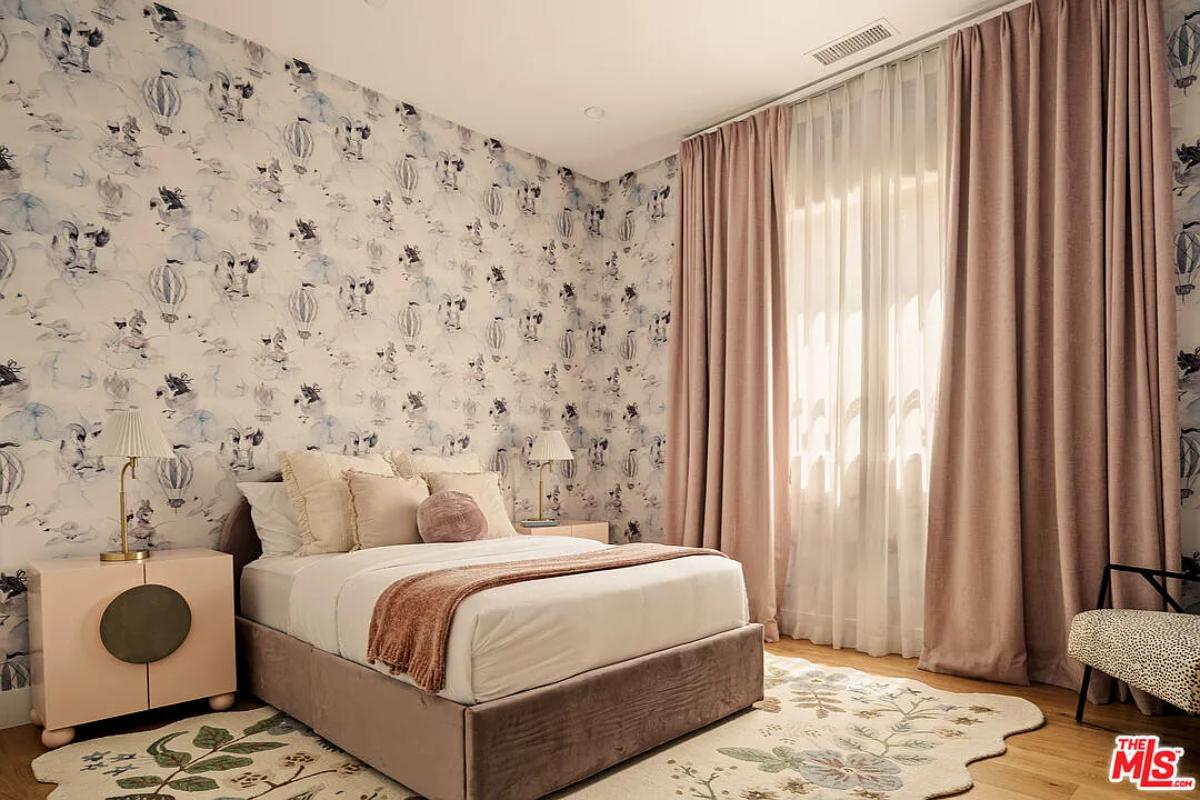 Bedroom with a large bed and hardwood floors.