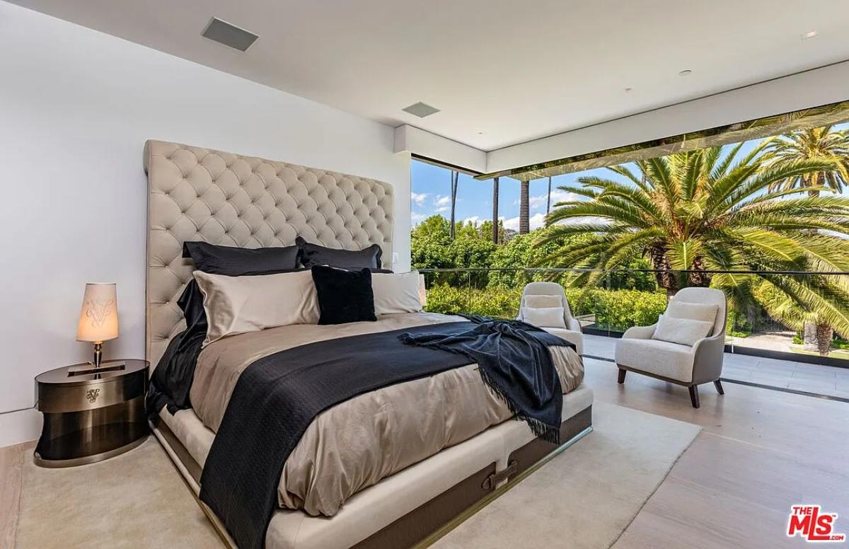 Bedroom with a large bed and hardwood floors.