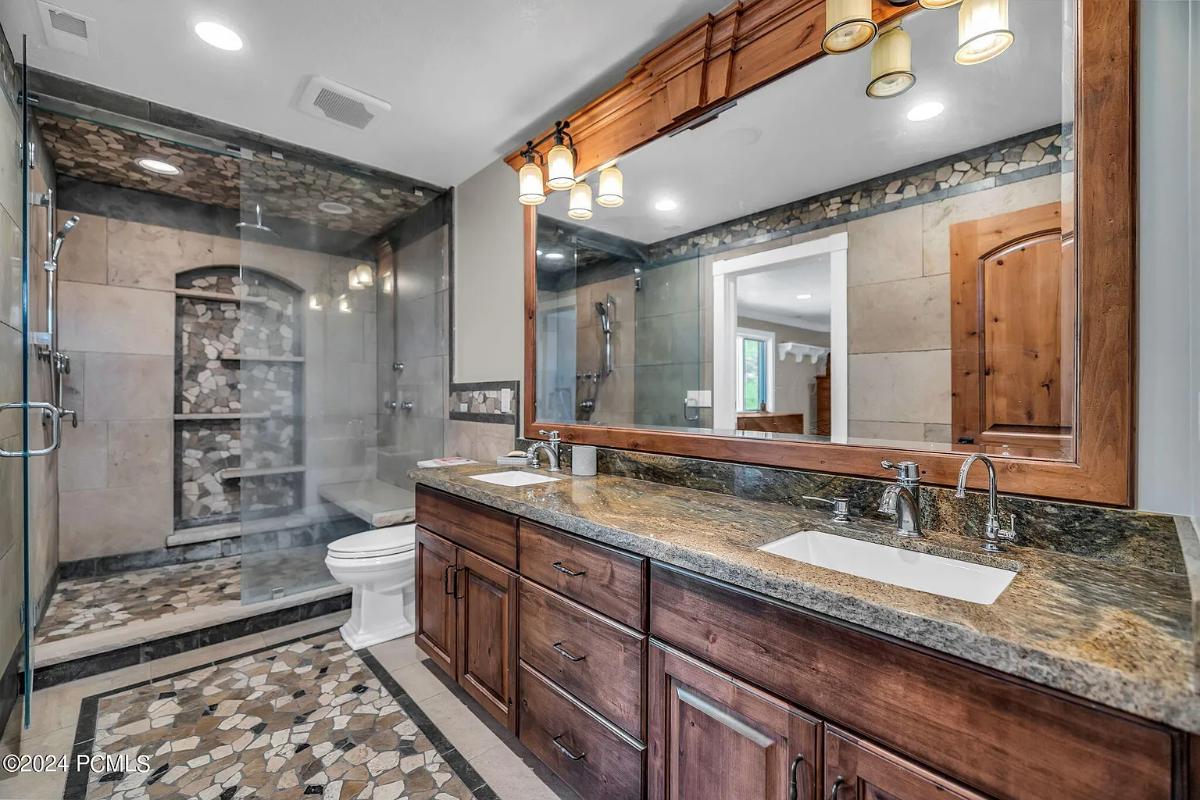 Bathroom with a sink, toilet and a walk-in shower.