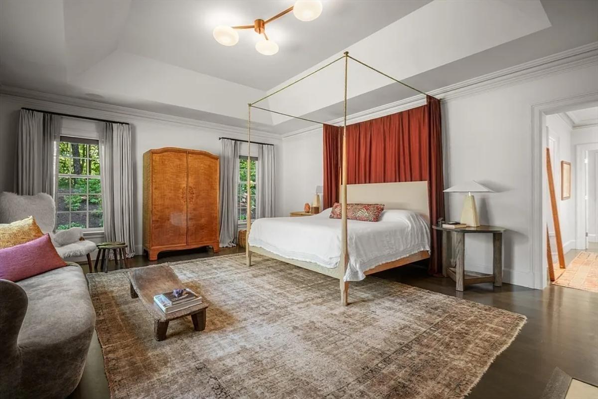 Bedroom with a large bed and glass windows.