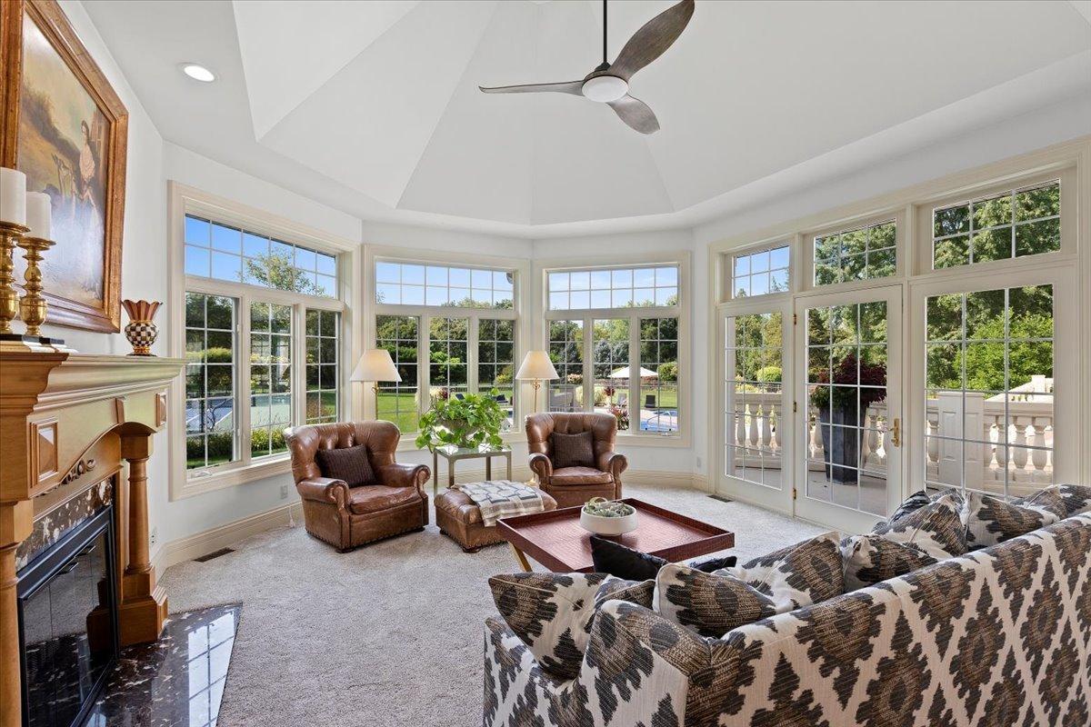 Living room with carpet flooring and a fireplace.