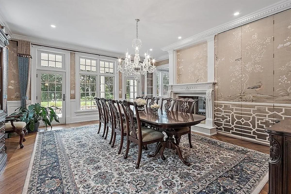 Dining room with a chandelier and a fireplace.