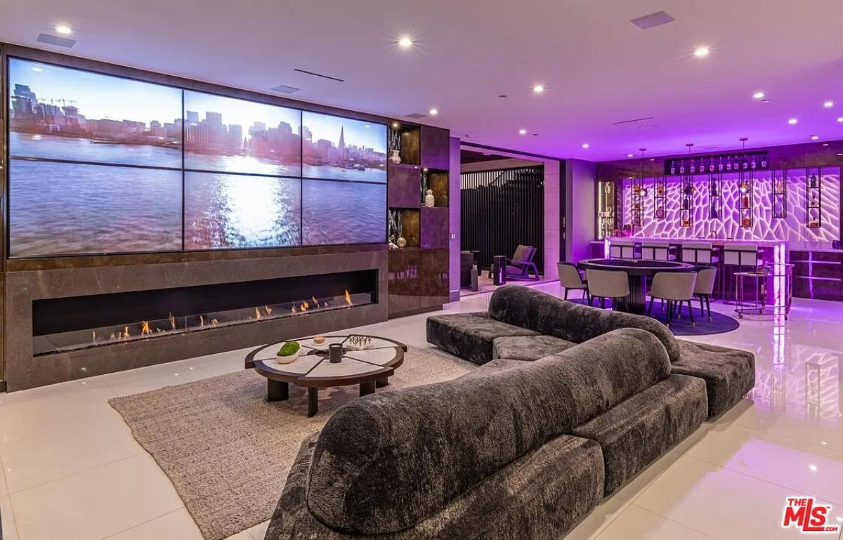 Recreation room with a fireplace and a bar.