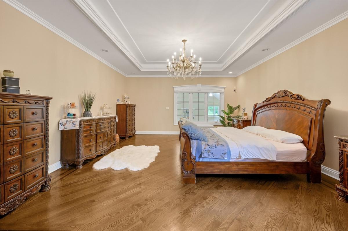 Bedroom with a large bed and hardwood floors.