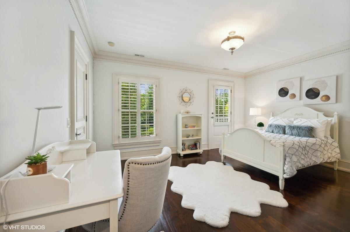 Bedroom with a large bed and hardwood floors.