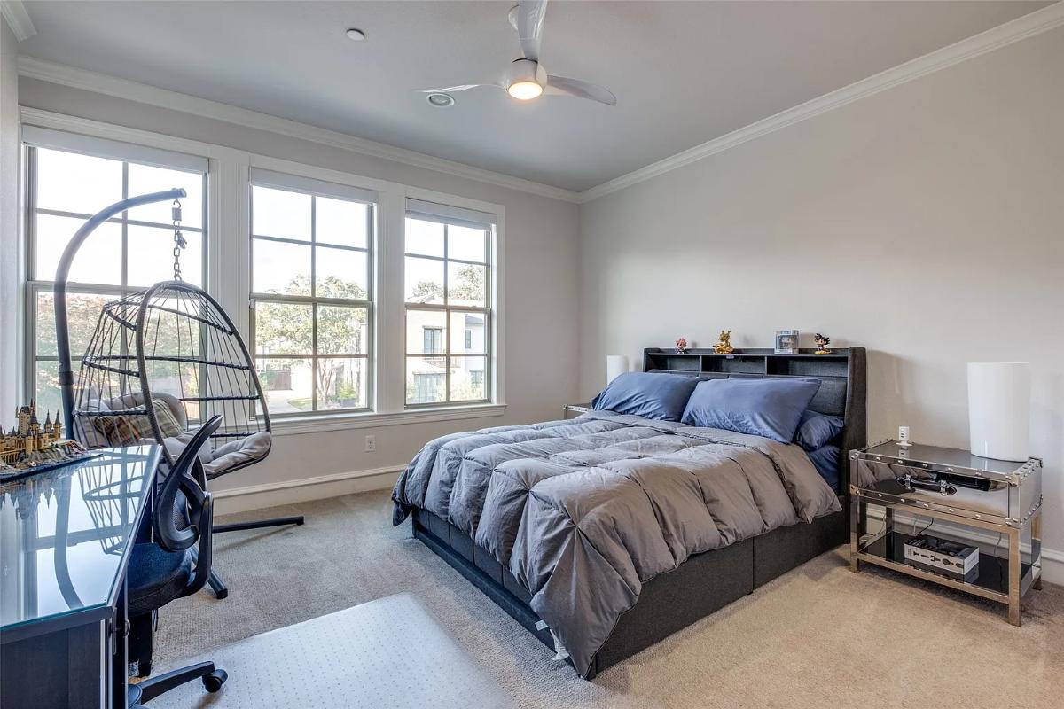 Bedroom with a large bed and carpet flooring.