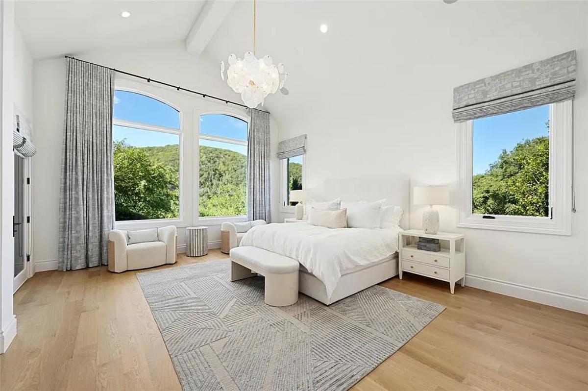 Bedroom with a large bed and hardwood floors.