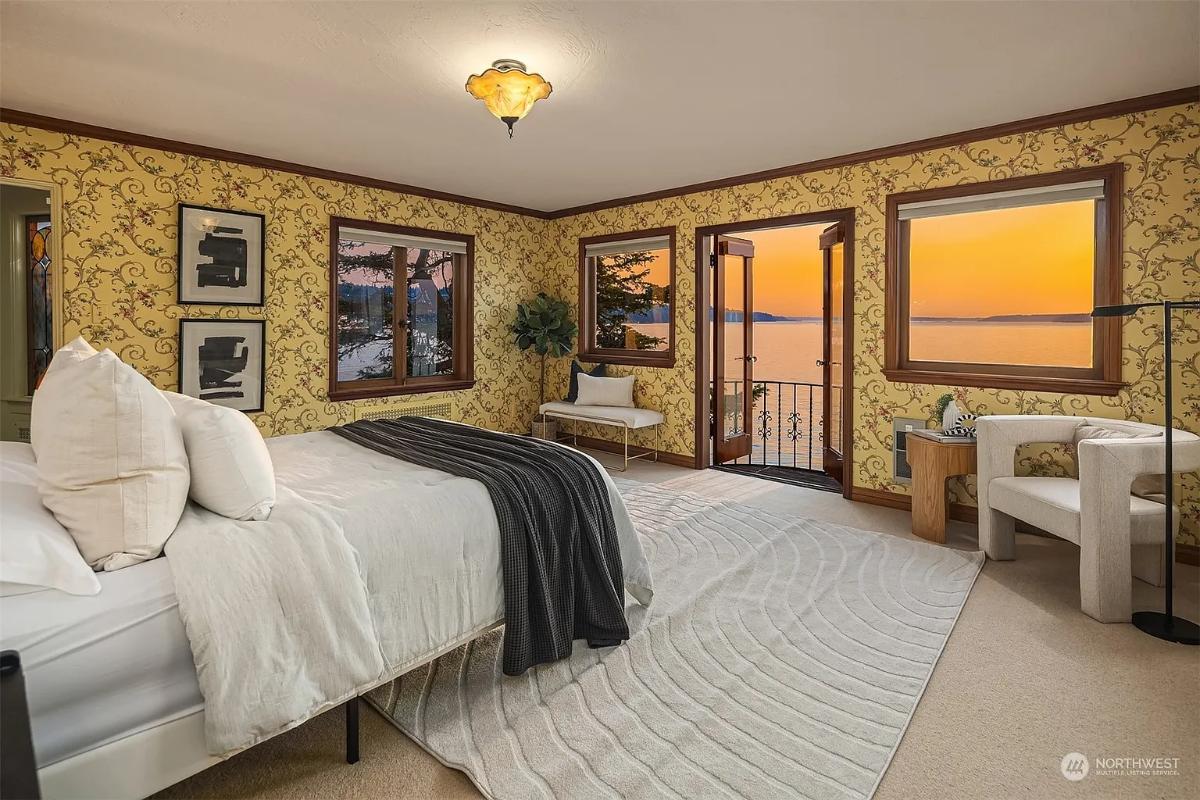 Bedroom with a large bed and carpet flooring.