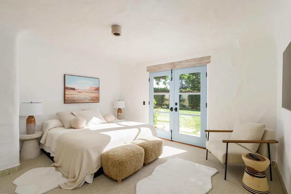 Bedroom with a large bed and carpet flooring.