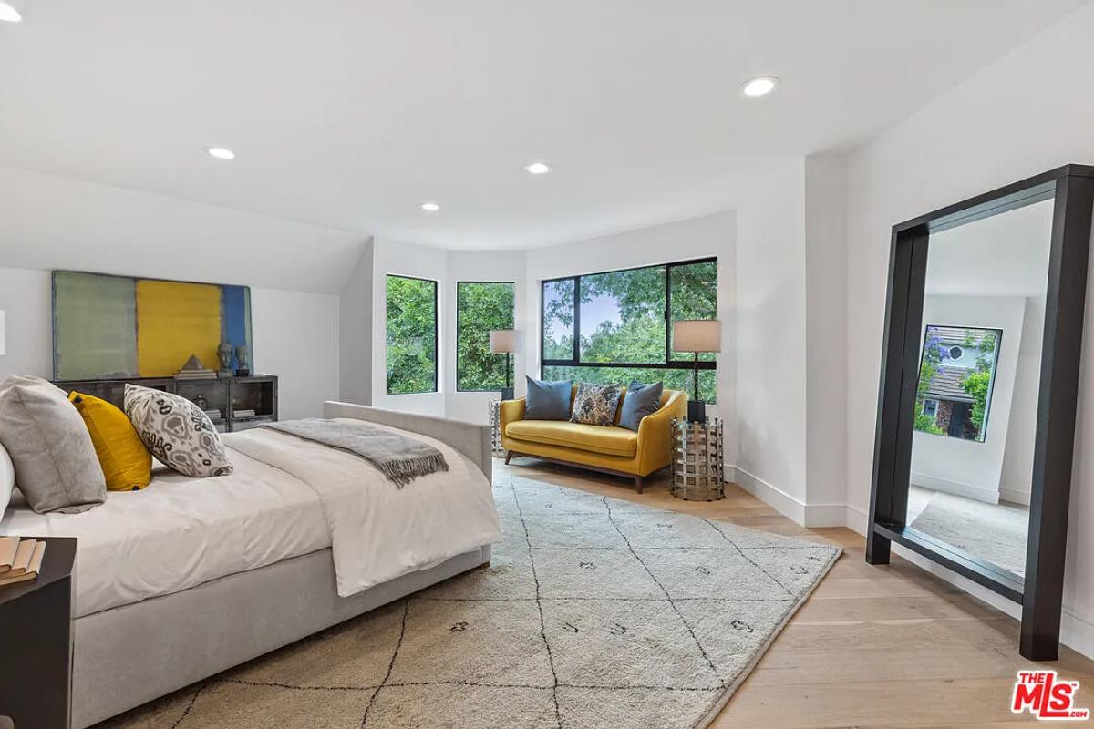 Bedroom with a large bed and hardwood floors.