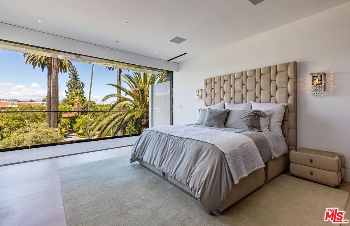 Bedroom with a large bed and hardwood floors.