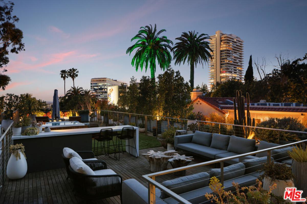Rooftop deck with a living space and a hot tub.