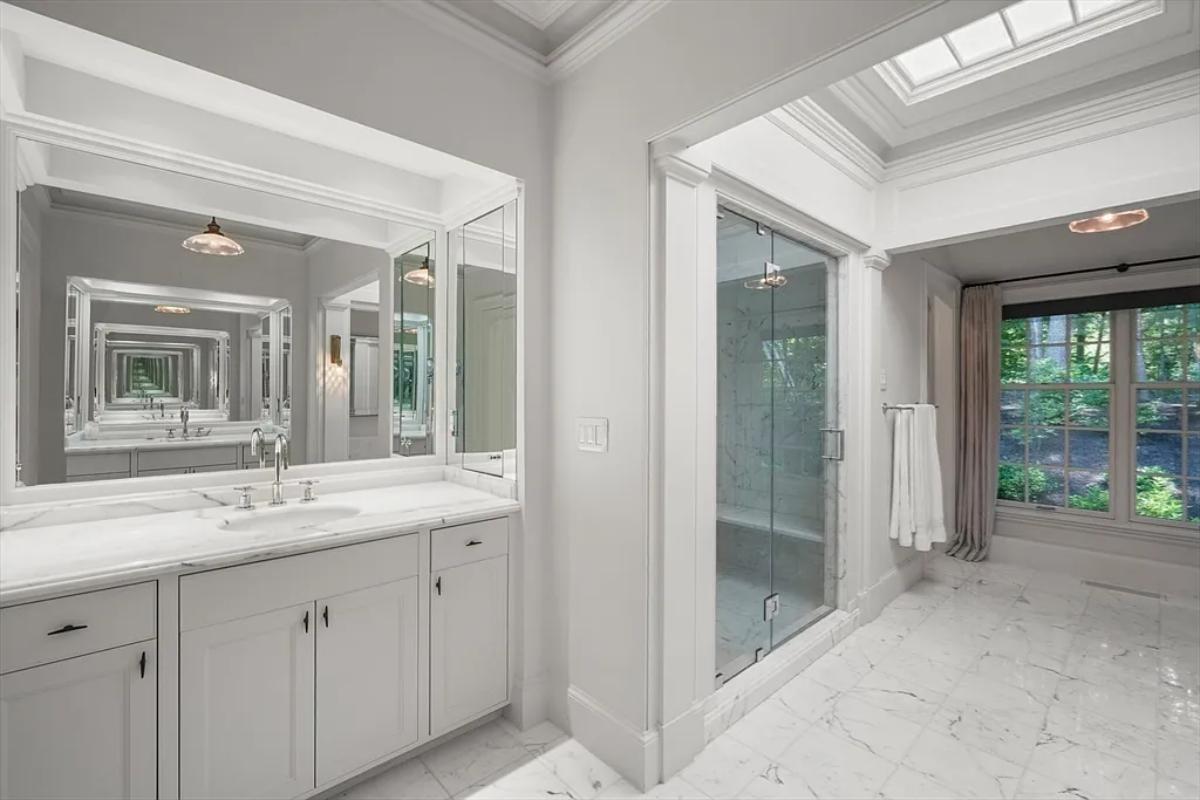 Bathroom with a custom-made vanity and a walk-in shower.