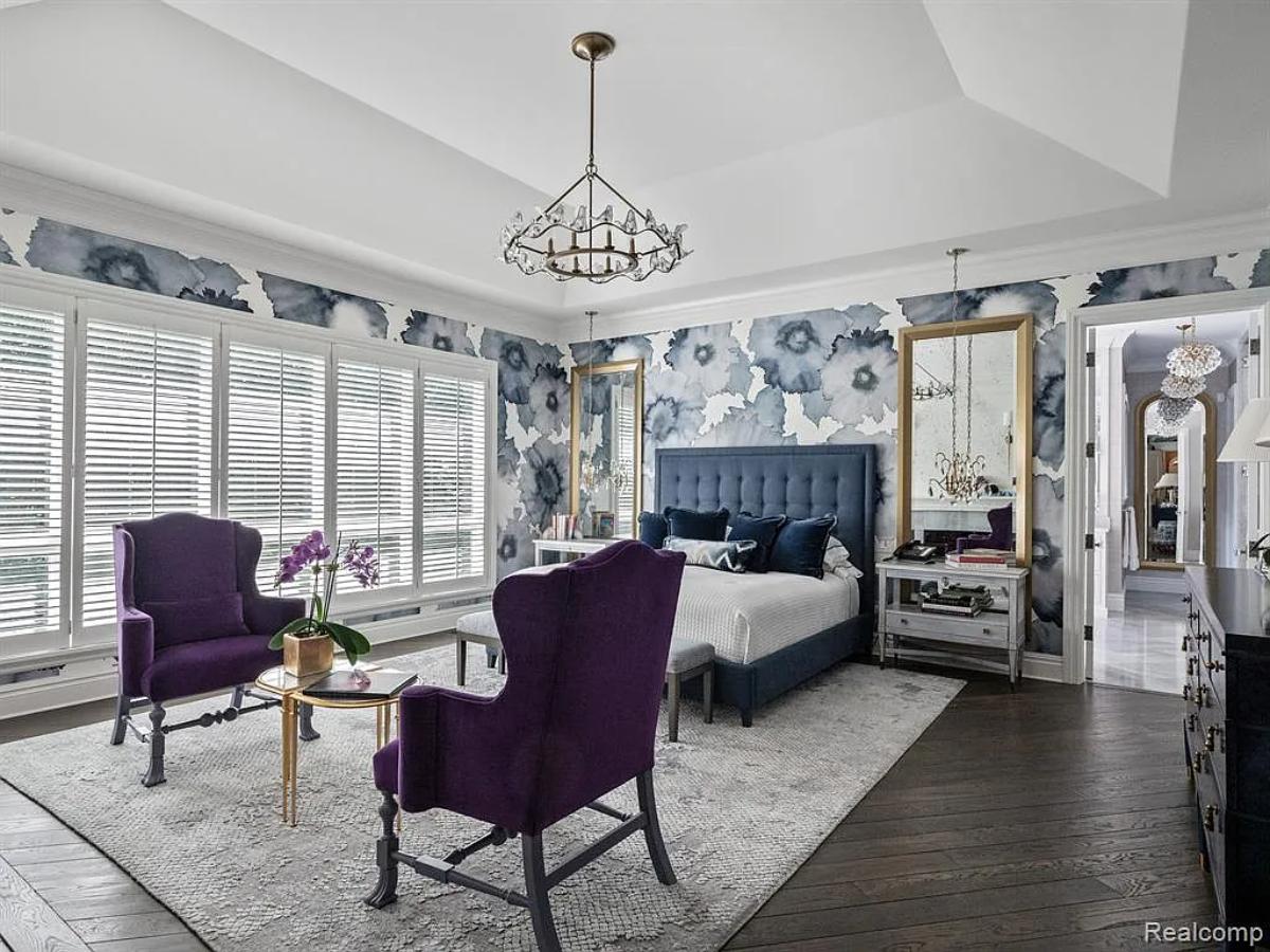 Bedroom with a large bed and hardwood floors.
