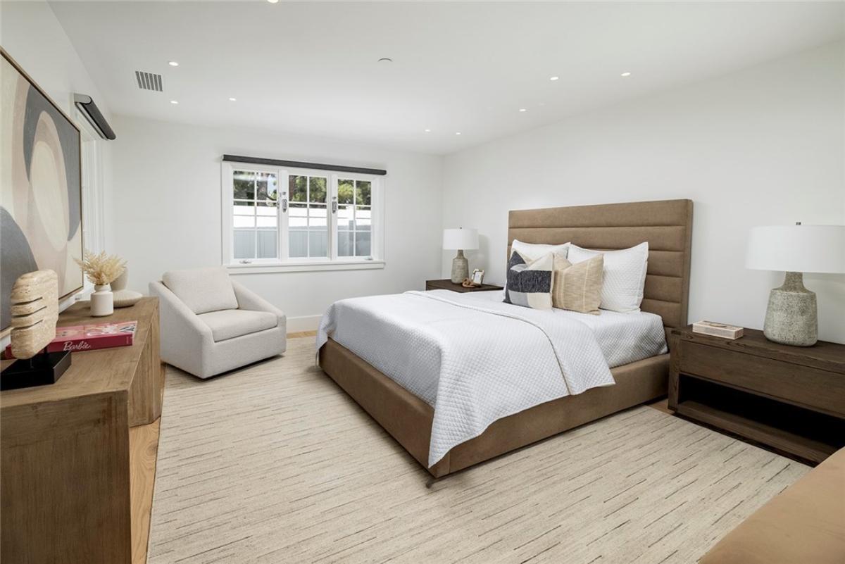 Bedroom with a large bed and carpet flooring.