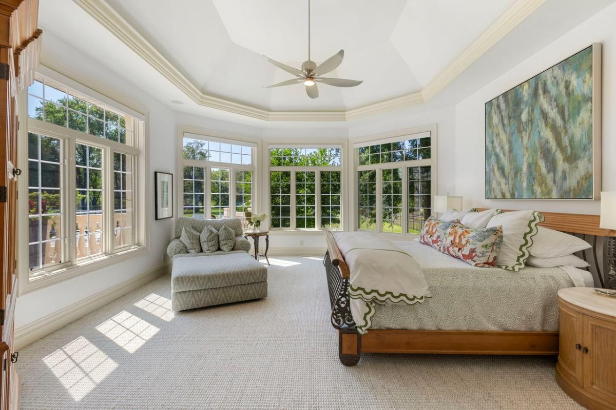 Bedroom with a large bed and carpet flooring.