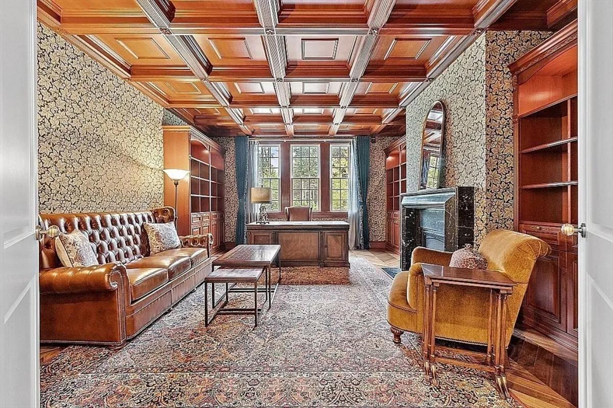 Home office with coffered ceilings and a fireplace.