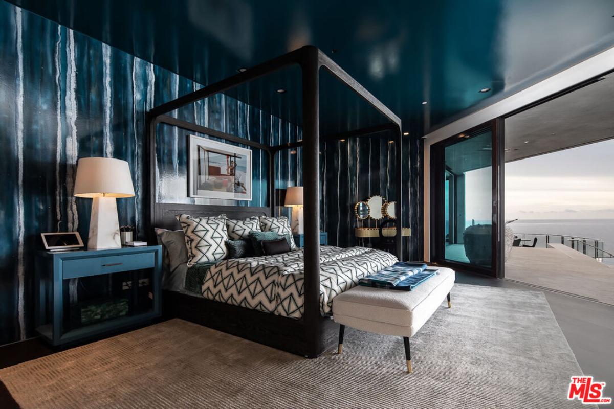 Bedroom with a large bed and sliding glass doors.