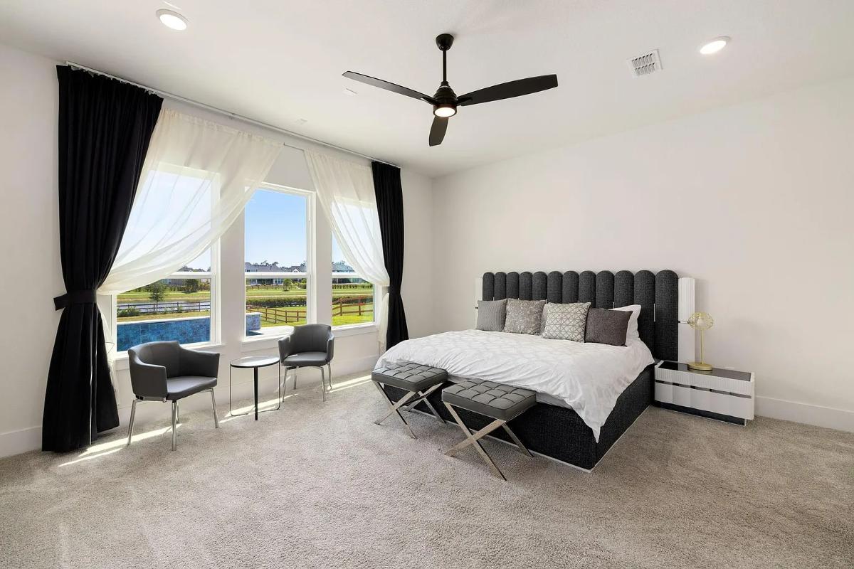 Bedroom with carpet flooring and glass windows.