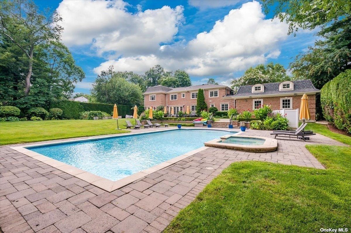 Rear view of the mansion with a pool.