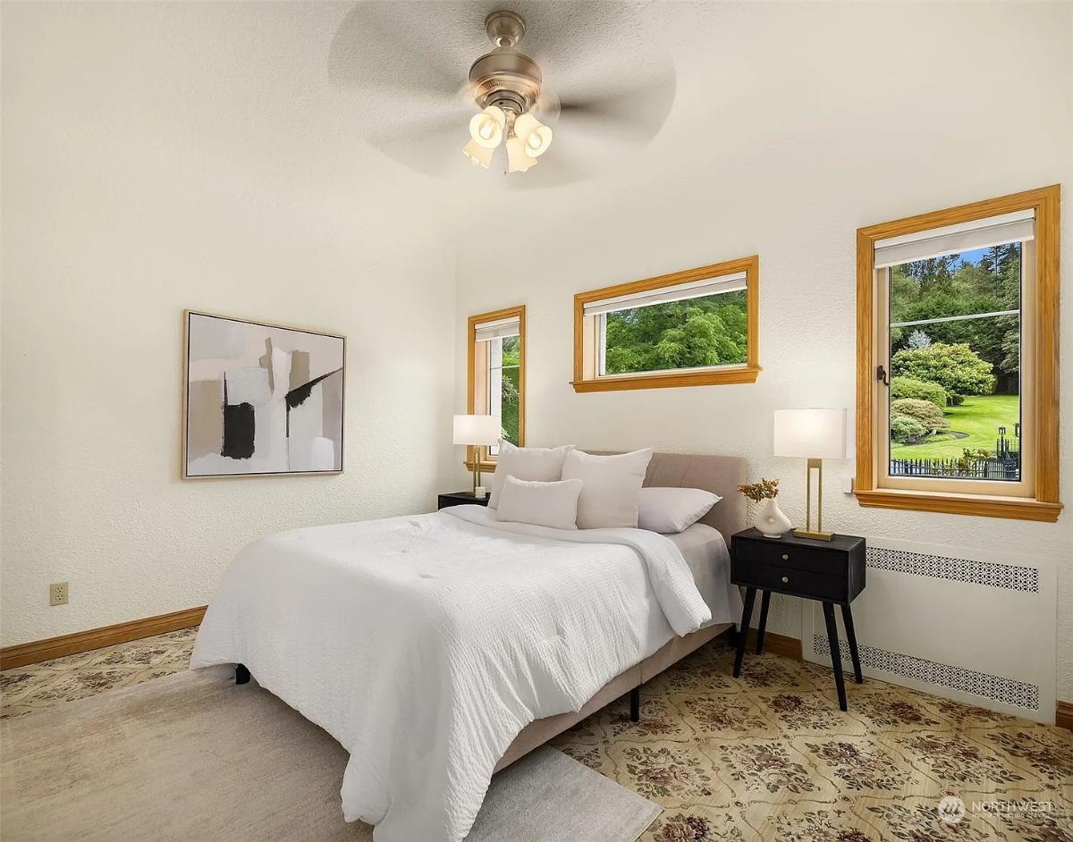 Bedroom with a large bed and carpet flooring.