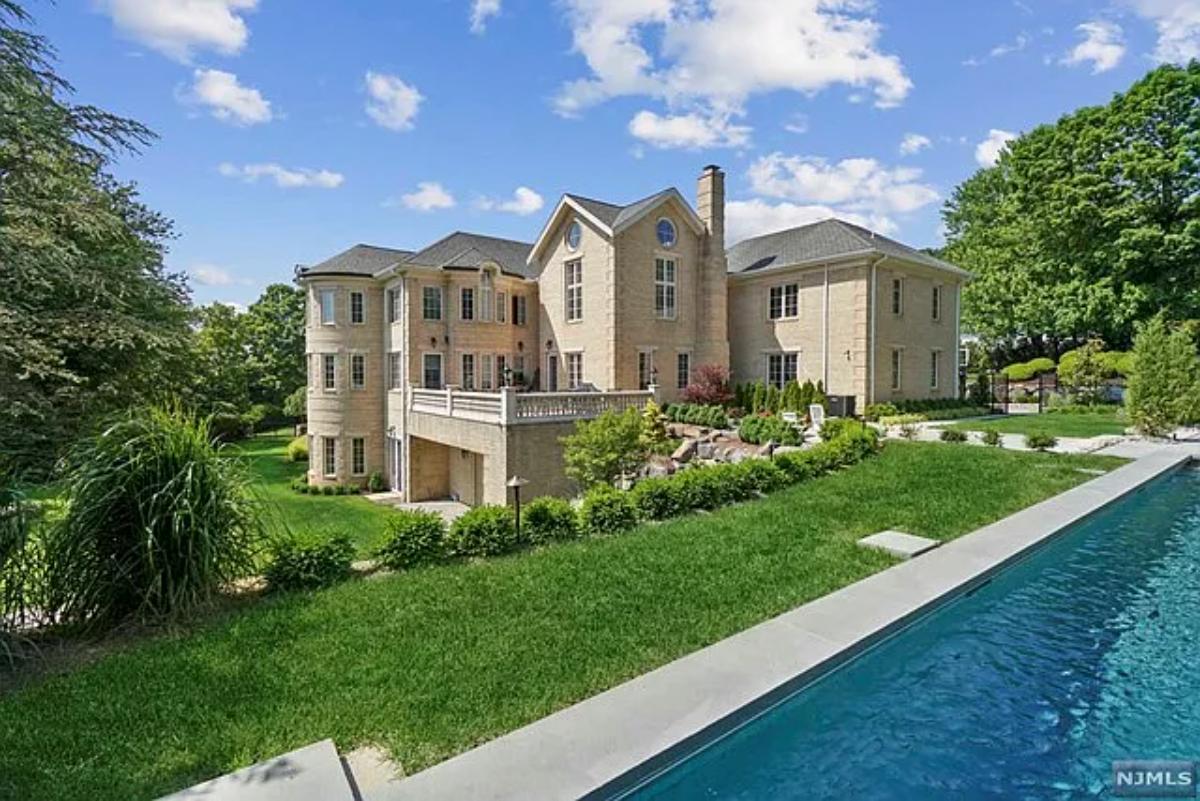 Exterior view of the mansion with a pool.