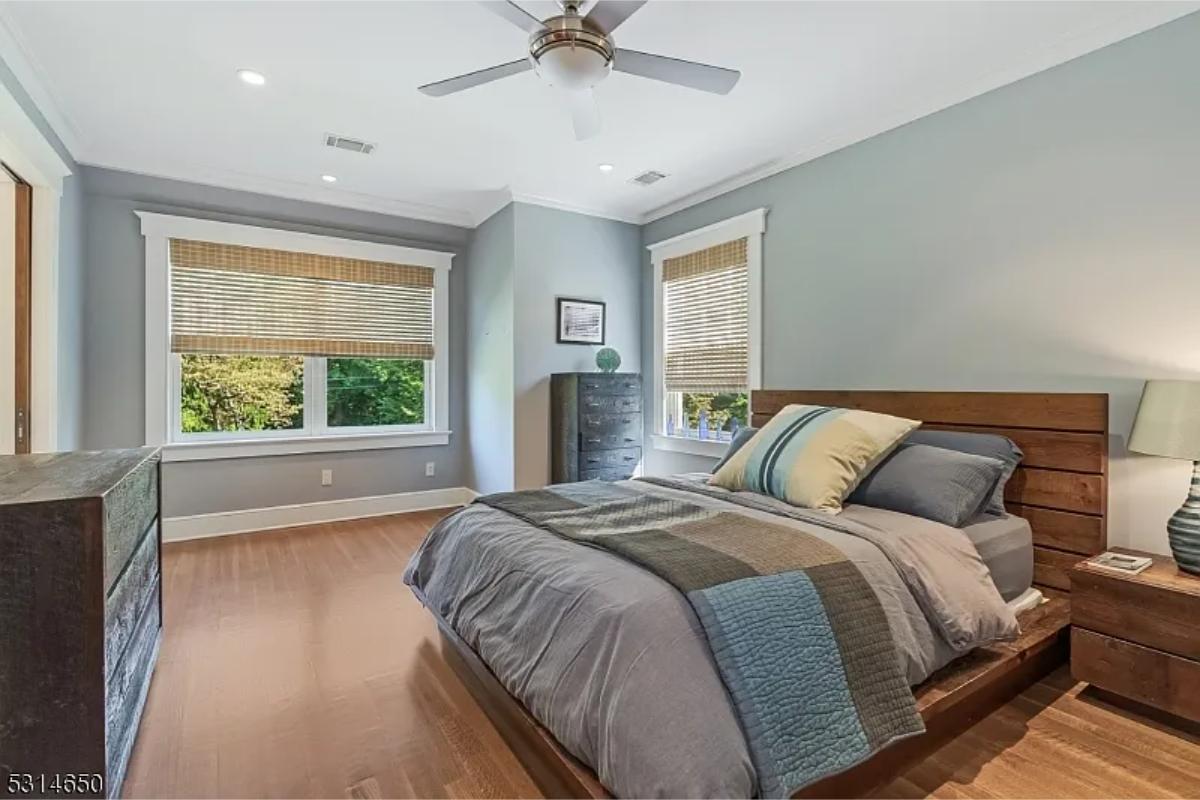 Bedroom with a large bed and hardwood floors.