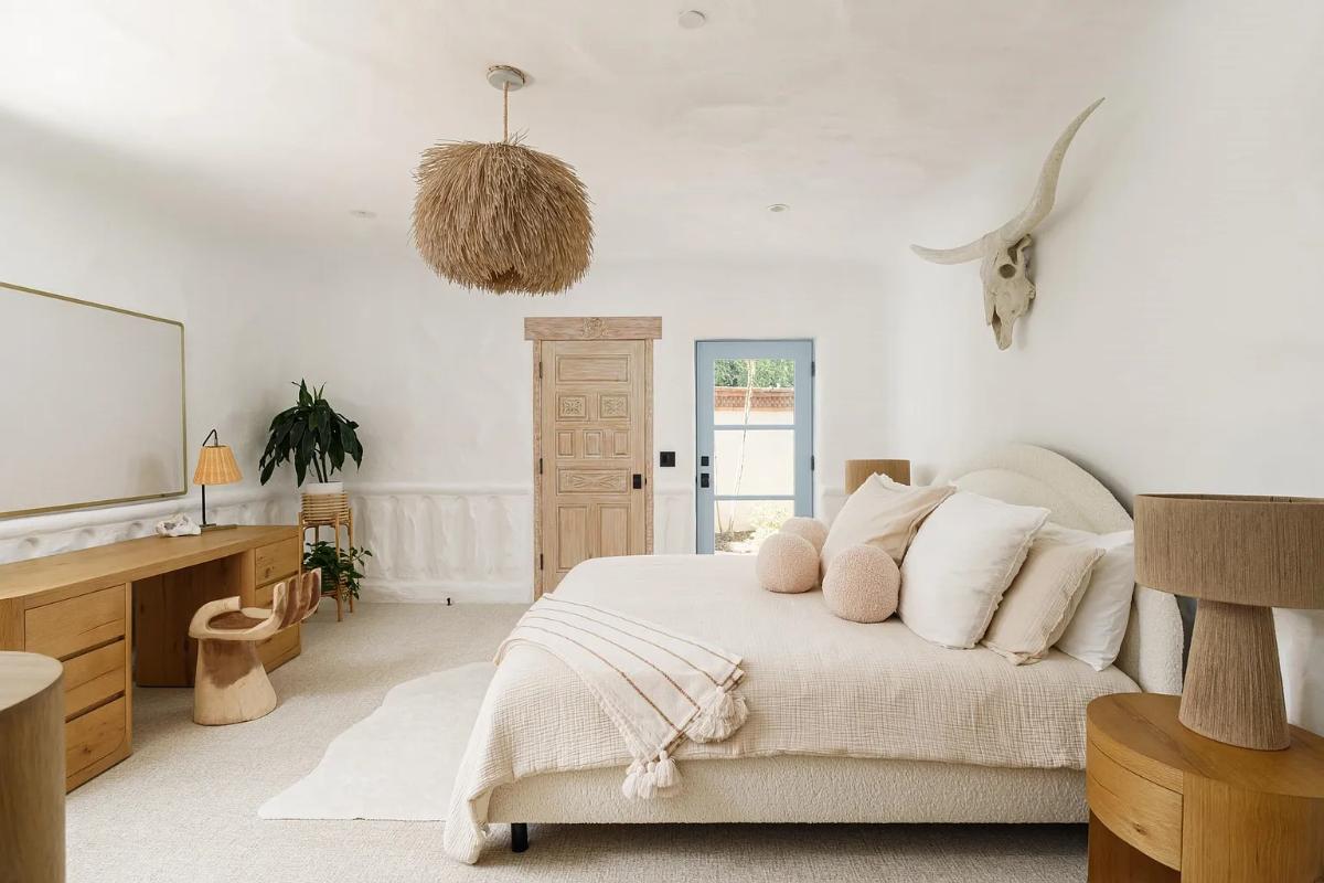 Bedroom with a large bed and carpet flooring.