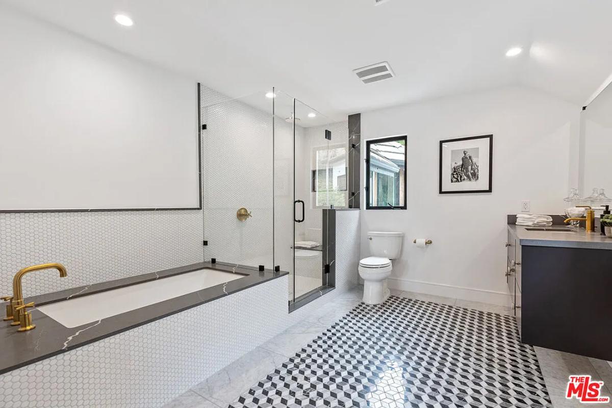 Bathroom with a sink, a soaking tub and a walk-in shower.