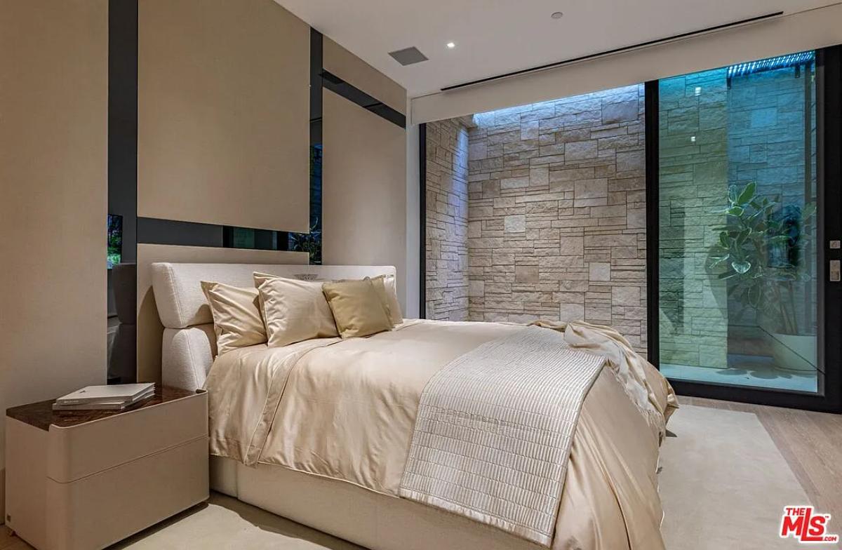 Bedroom with a large bed and hardwood floors.