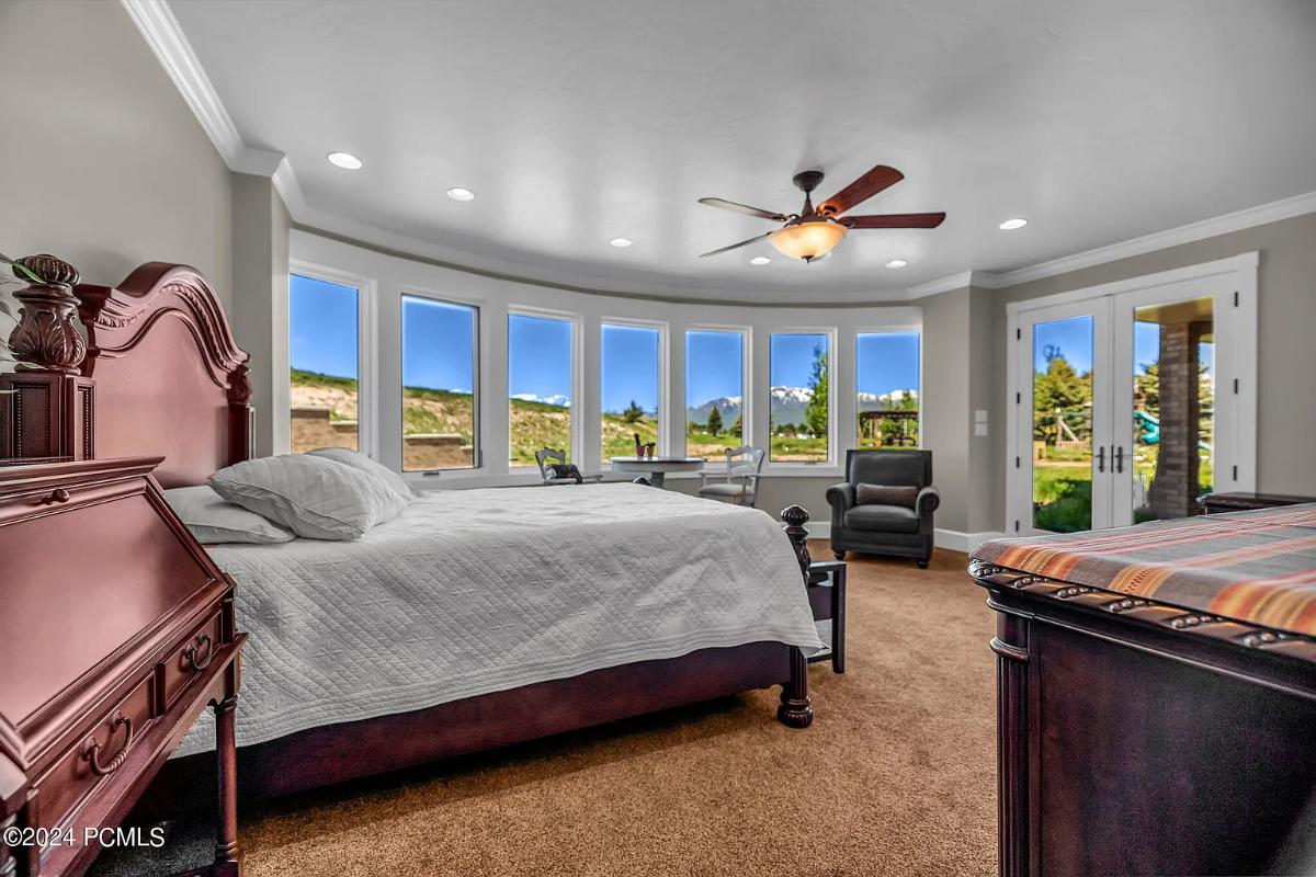 Bedroom with a large bed and carpet flooring.