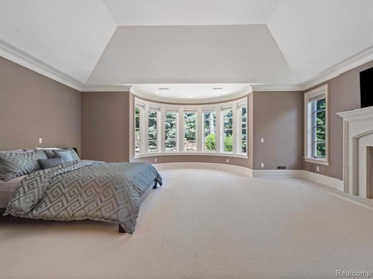 Bedroom with a large bed and carpet flooring.