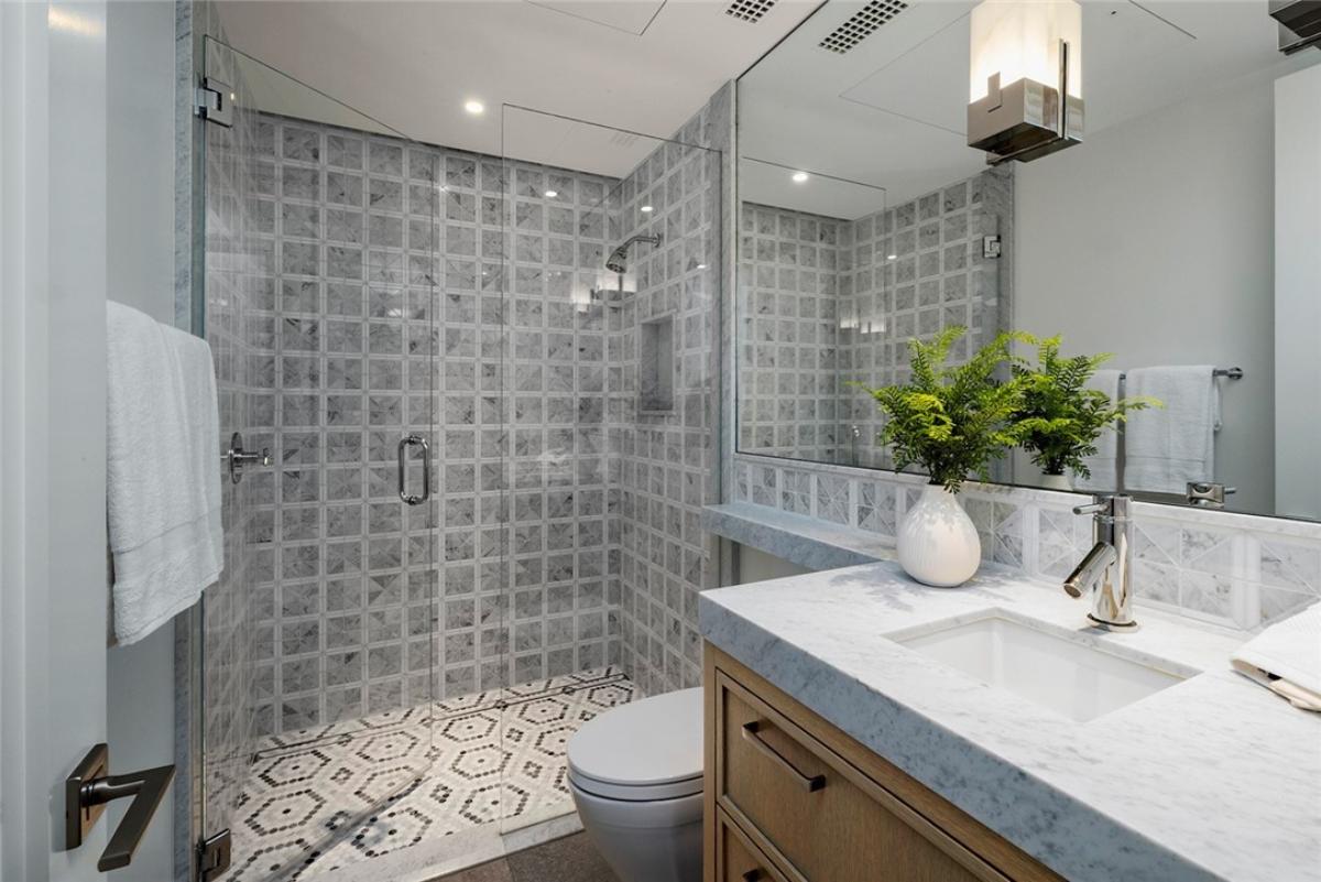 Bathroom with a sink, toilet and a walk-in shower.