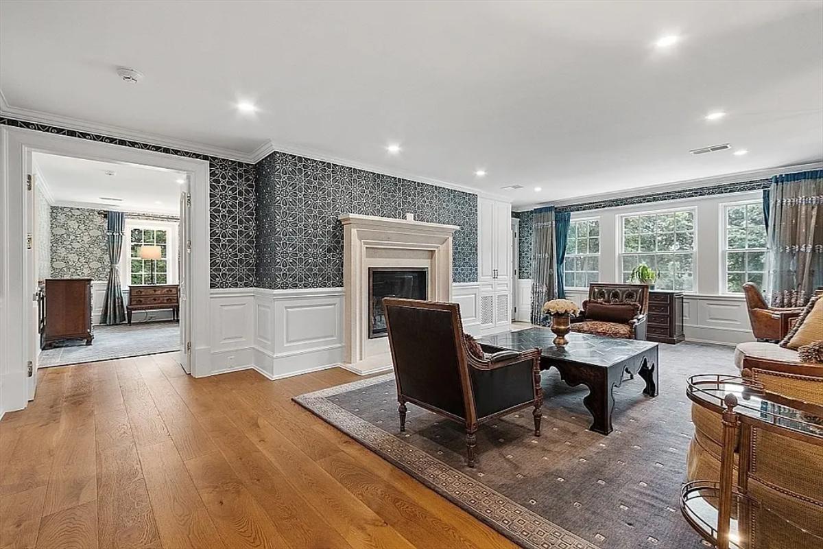 Living room with hardwood floors and a fireplace.