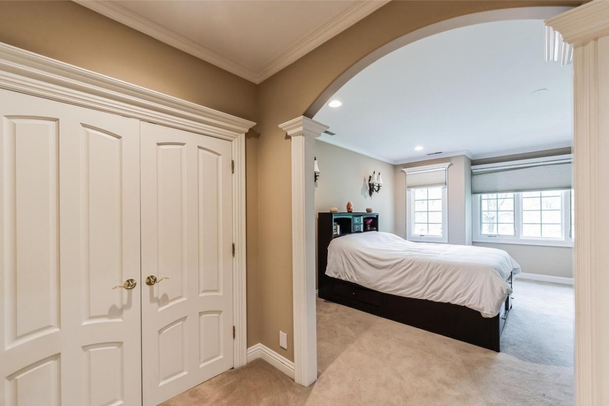 Bedroom with a large bed and carpet flooring.
