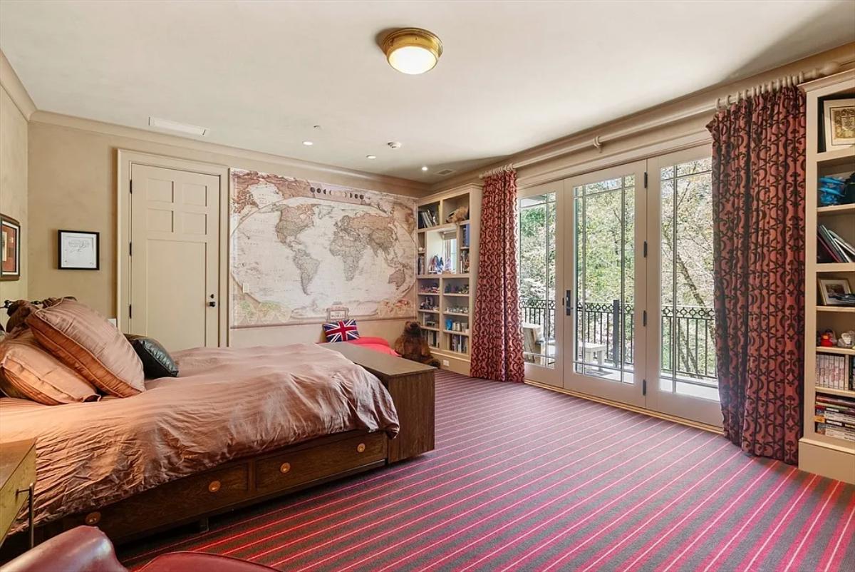 Bedroom with a large bed and carpet flooring.