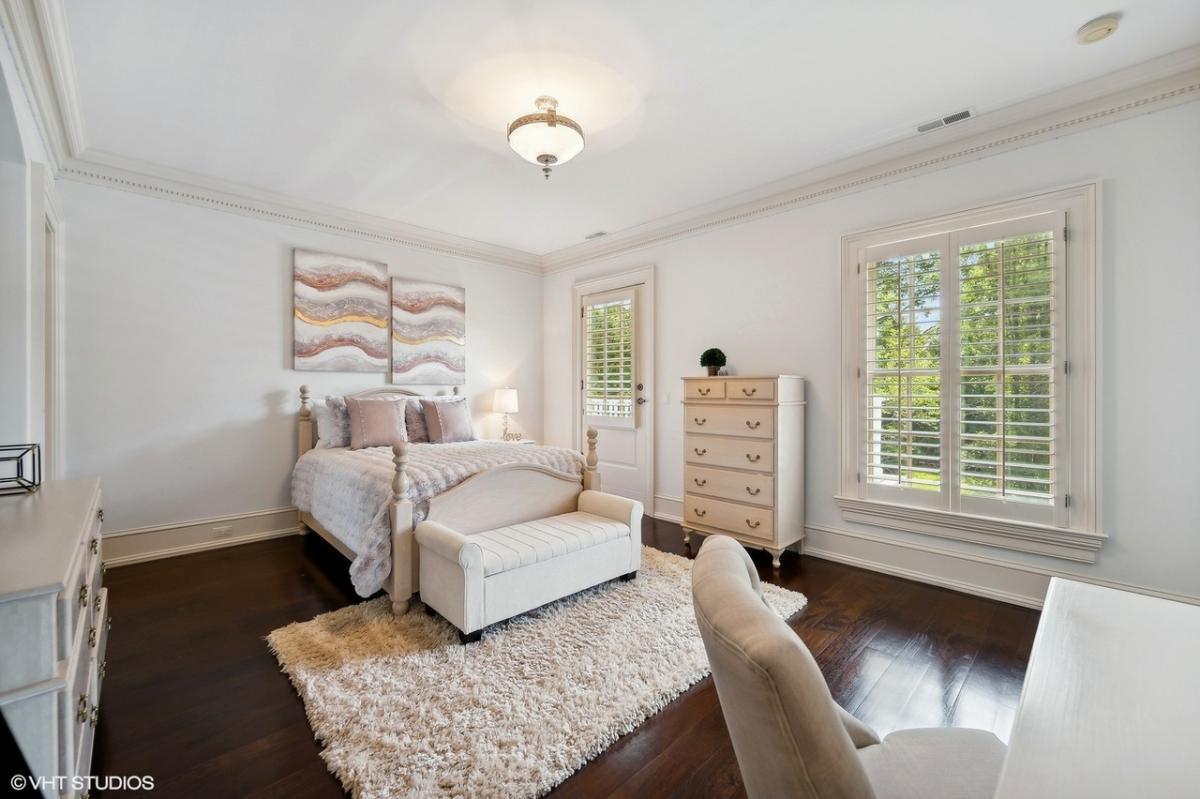 Bedroom with a large bed and hardwood floors.