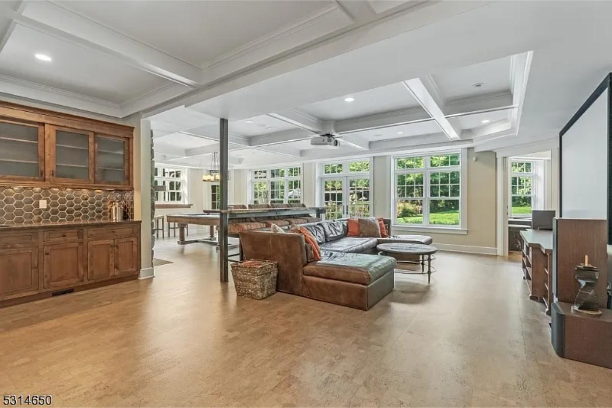 Recreation room with couches and a billiards table.