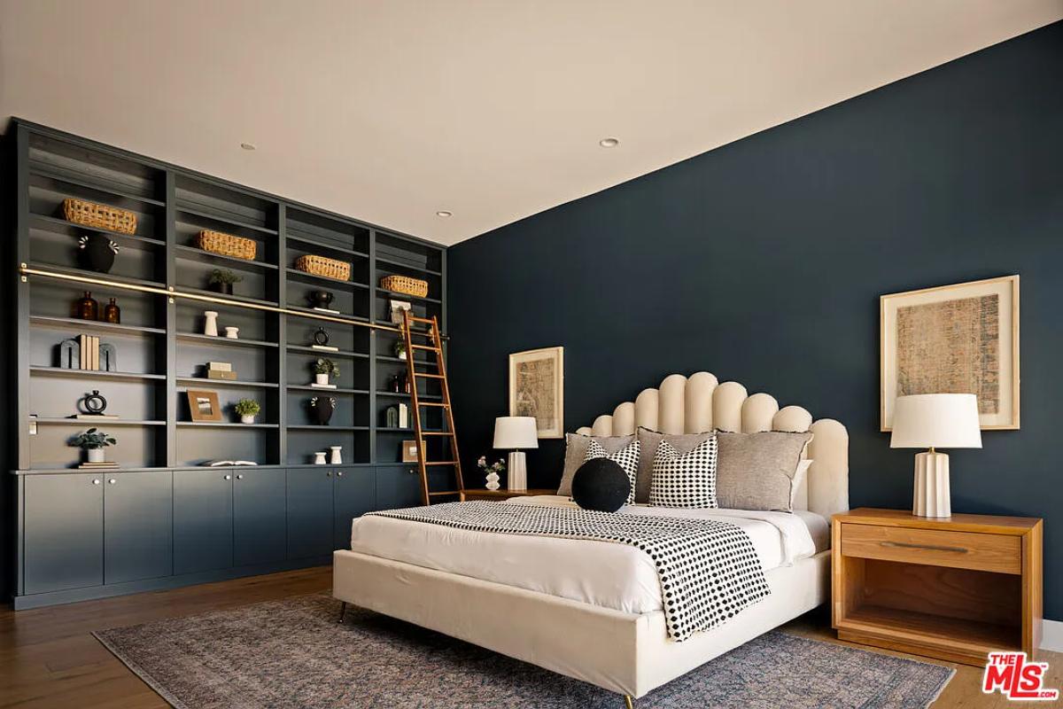 Bedroom with a large bed and hardwood floors.