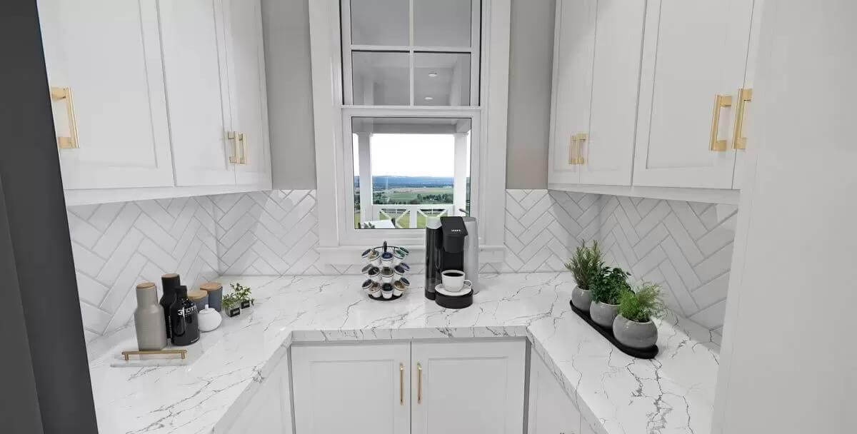Pantry with marble countertops and white cabinetry accentuated by brass handles.