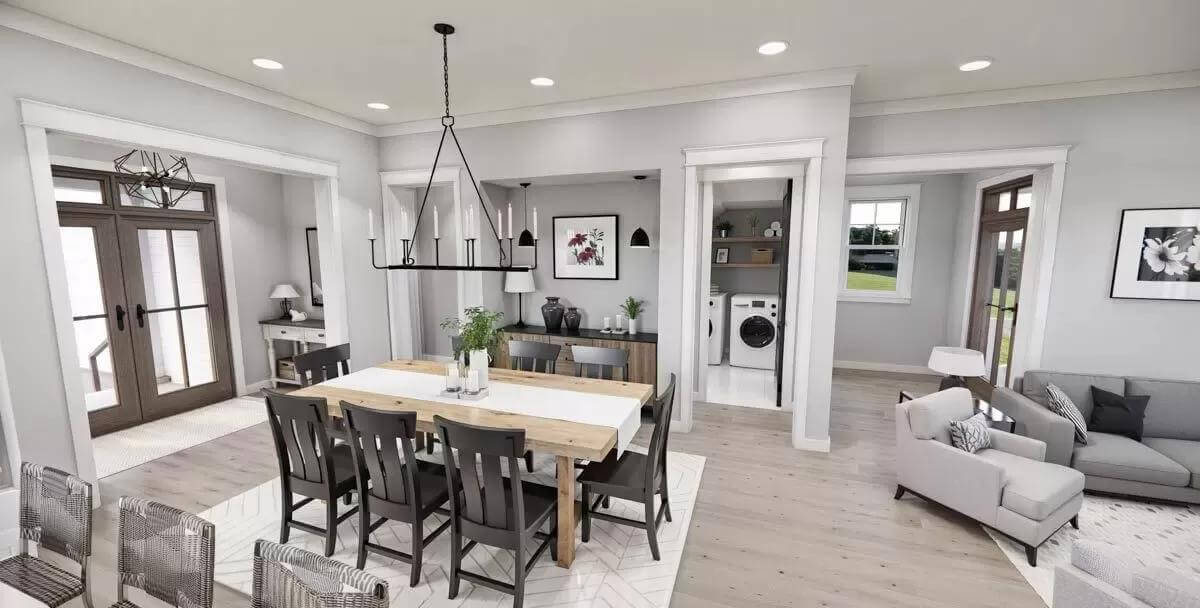 Dining area with an 8-seater dining set illuminated by a wrought iron chandelier.