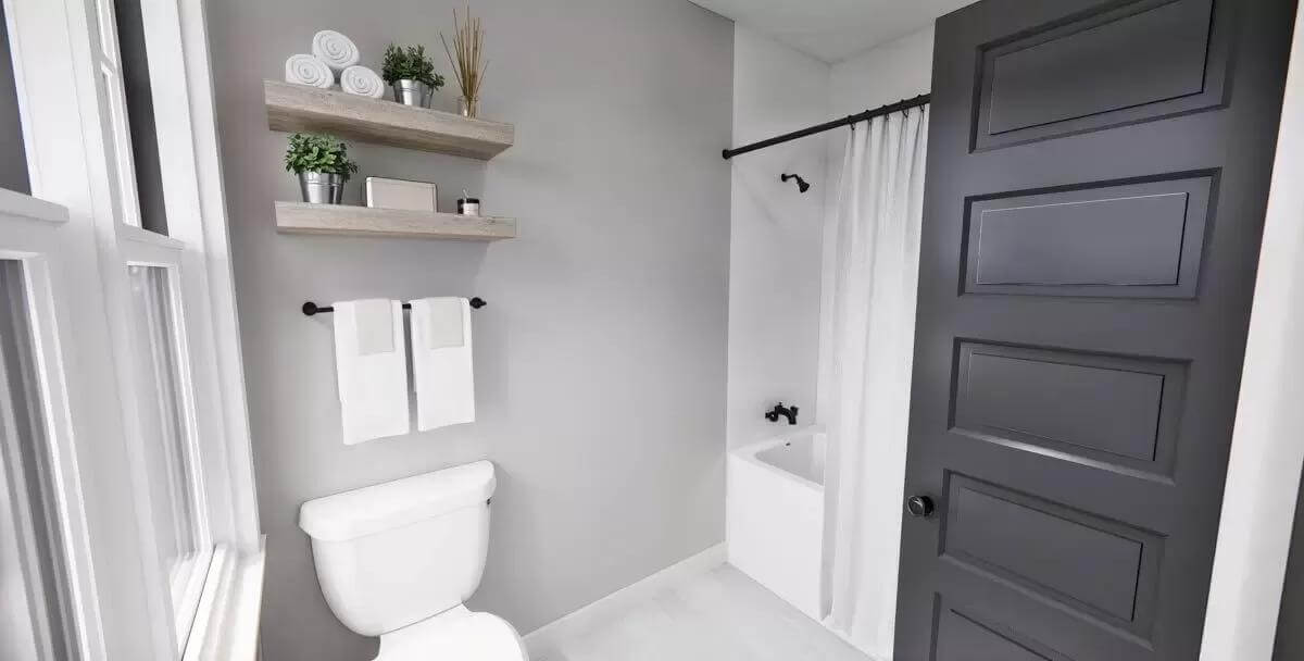 Bathroom with a tub and shower combo, and floating shelves fixed above the toilet.