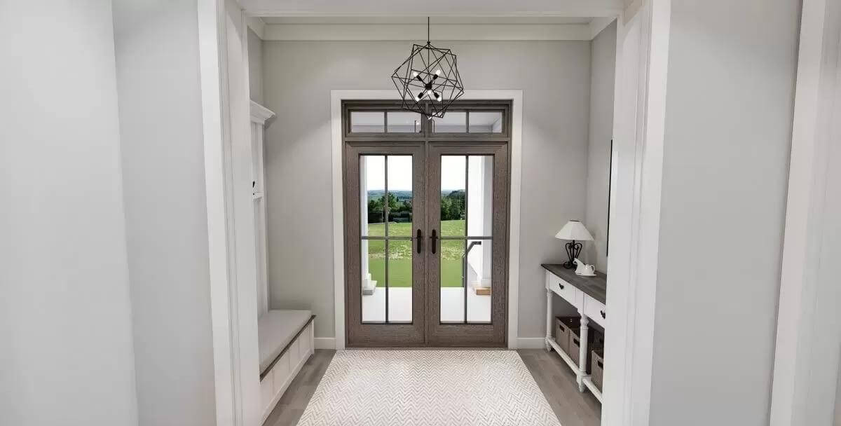Rear entry with a console table and a cushioned bench integrated with coat hooks.