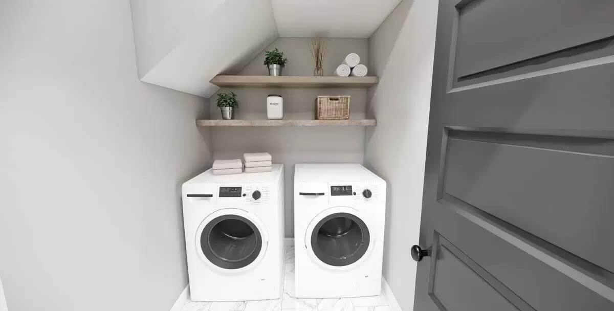 Laundry room with front-load appliances topped by floating shelves.