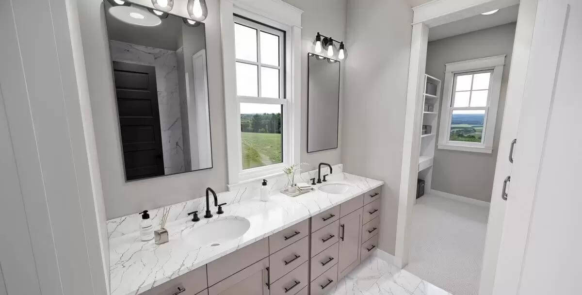 Primary bathroom with a dual sink vanity and a walk-in closet.