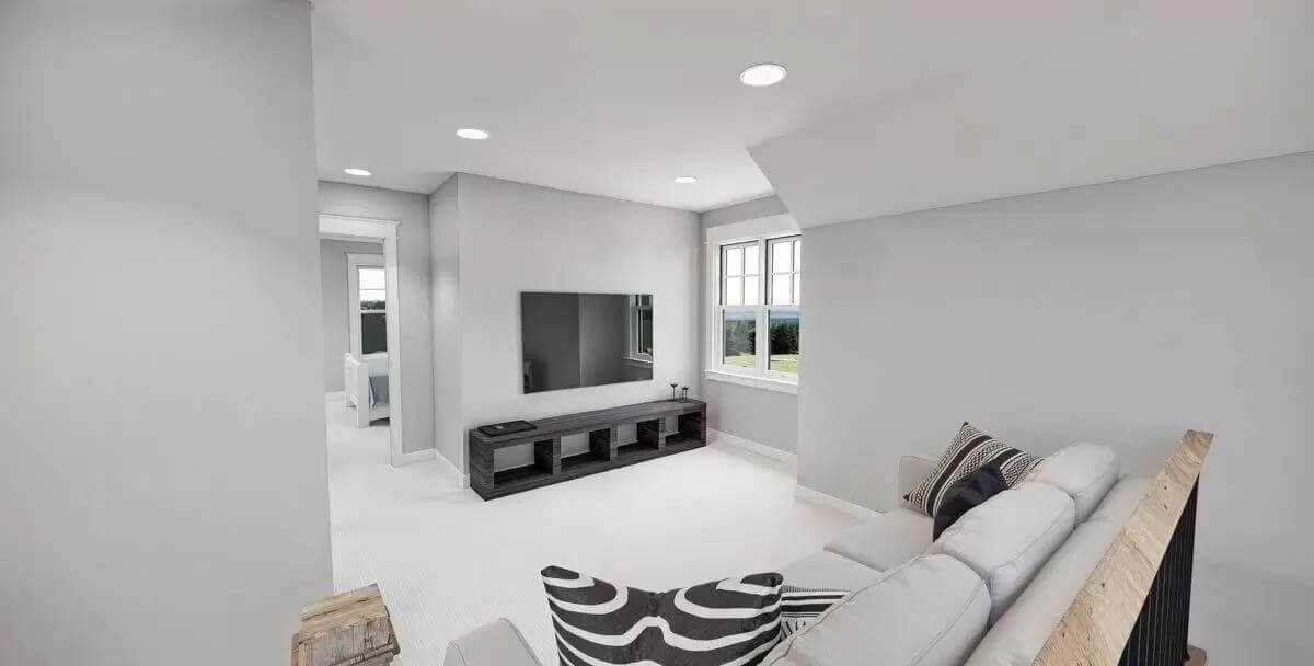 Loft with a wall-mounted TV and a sectional sofa.